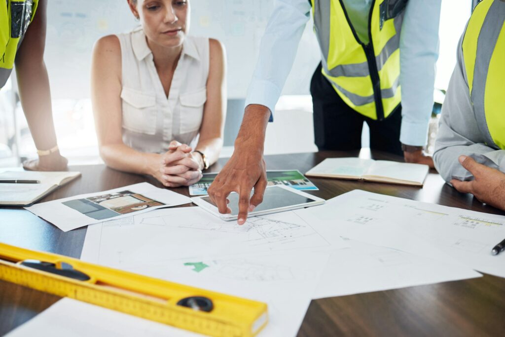 Construction, blueprint and planning with architect in meeting for consulting, project management a